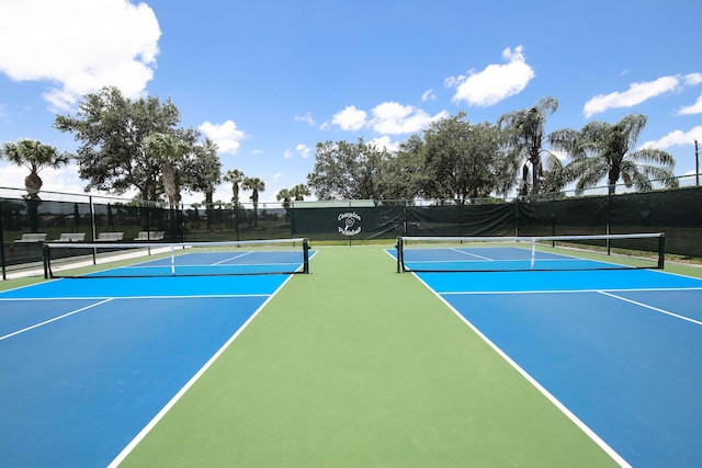 view of tennis court with basketball hoop