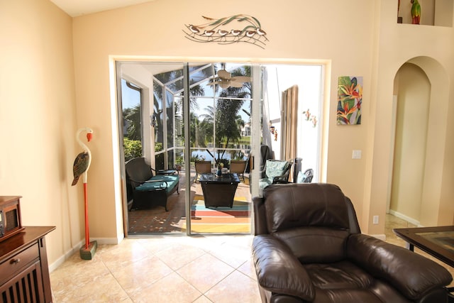 doorway featuring ceiling fan and light tile patterned floors