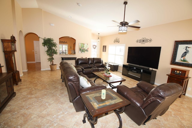 living room featuring a healthy amount of sunlight, ceiling fan, and lofted ceiling