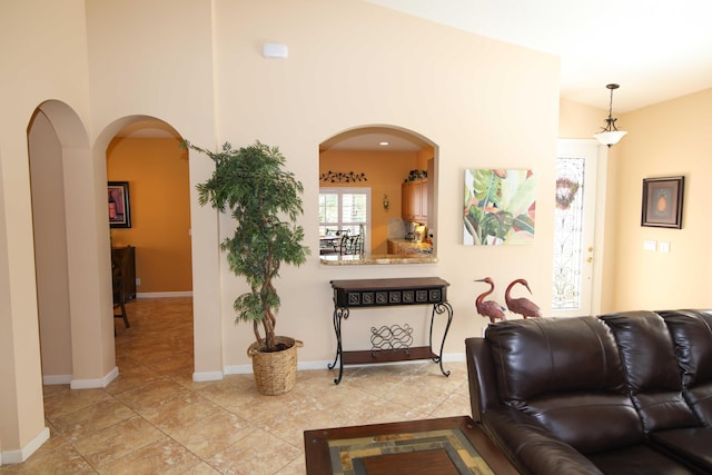 living room featuring lofted ceiling and light tile patterned floors