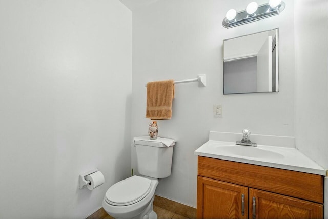 bathroom featuring tile patterned flooring, vanity, and toilet