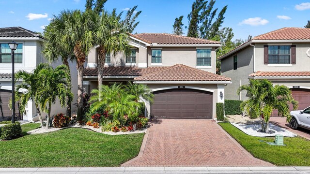 mediterranean / spanish-style home with a garage