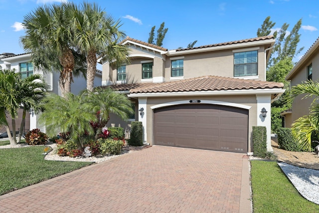 mediterranean / spanish home featuring a garage