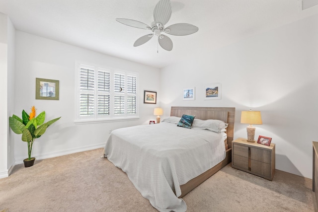 bedroom with ceiling fan and light colored carpet