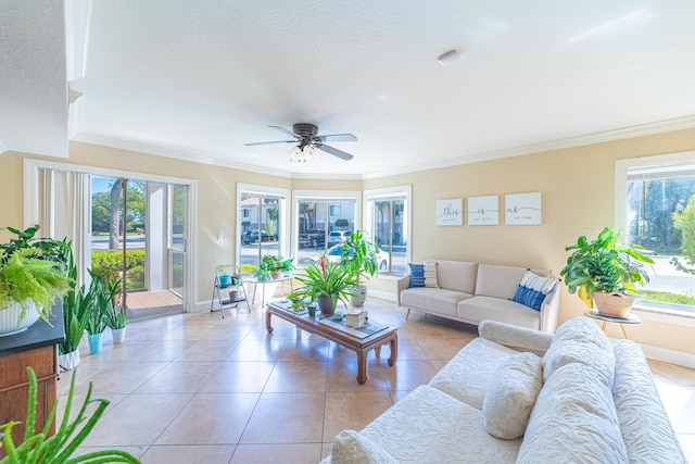 tiled living room featuring a healthy amount of sunlight, ornamental molding, and ceiling fan