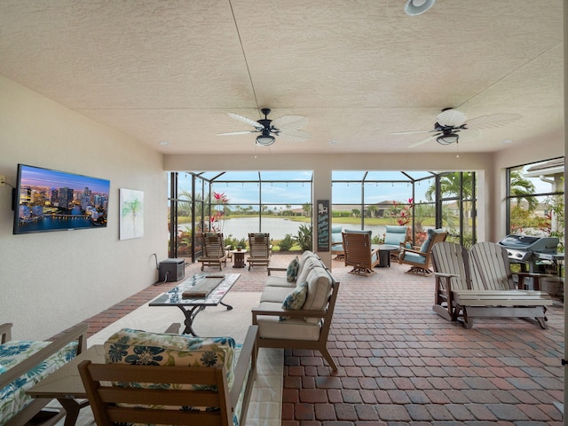 exterior space featuring a wealth of natural light, ceiling fan, and a water view