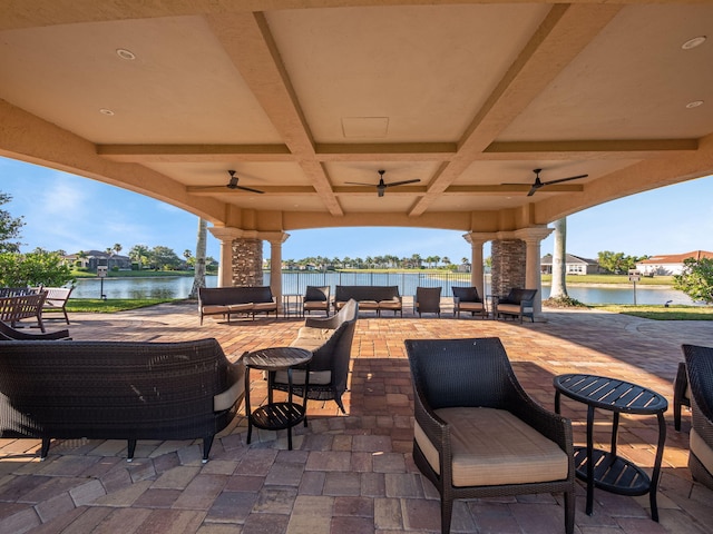 view of patio featuring a water view, ceiling fan, outdoor lounge area, and a gazebo