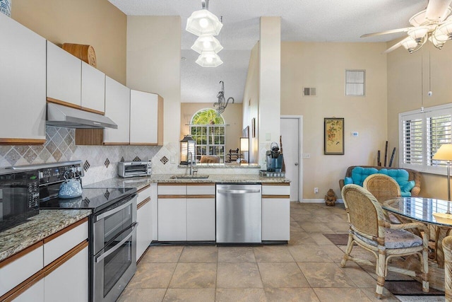 kitchen featuring sink, stainless steel appliances, decorative light fixtures, decorative backsplash, and white cabinets