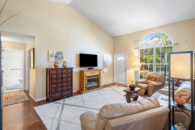 bedroom with ceiling fan, carpet floors, and a textured ceiling