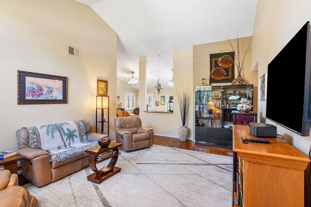 bedroom with two closets, ceiling fan, light carpet, and a textured ceiling