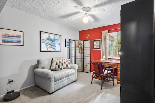 home office with ceiling fan, light colored carpet, and a textured ceiling