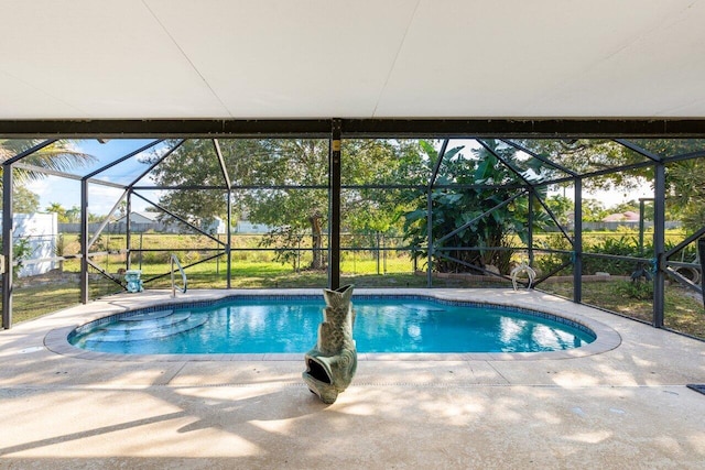 view of swimming pool featuring a patio and glass enclosure