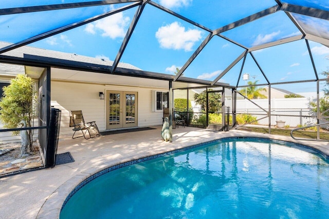 view of swimming pool with a lanai, french doors, and a patio