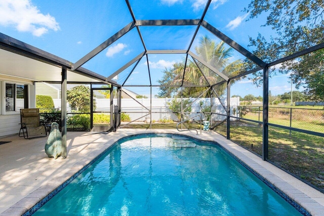 view of swimming pool with a lanai and a patio area