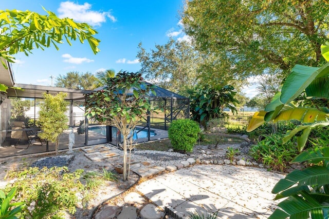 exterior space featuring a fenced in pool and a lanai