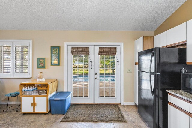 dining area with ceiling fan, light tile patterned floors, a textured ceiling, and high vaulted ceiling