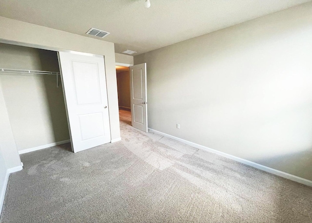 unfurnished bedroom with carpet floors and a closet