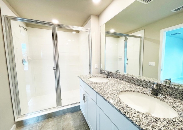 bathroom featuring tile patterned flooring, walk in shower, and vanity