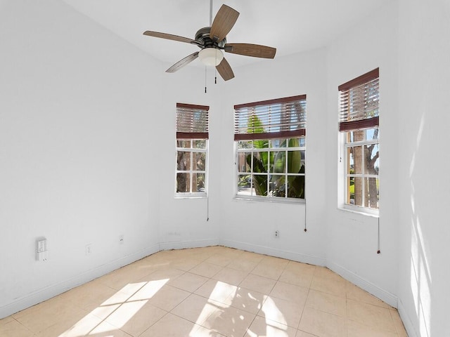 unfurnished room featuring ceiling fan and a healthy amount of sunlight