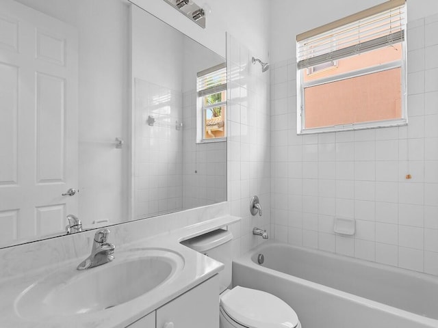 full bathroom featuring vanity, toilet, and tiled shower / bath combo