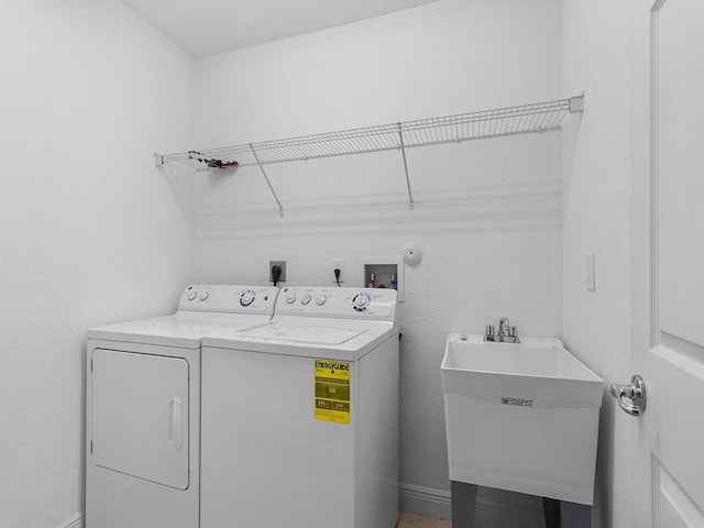 laundry room with washer and clothes dryer and sink