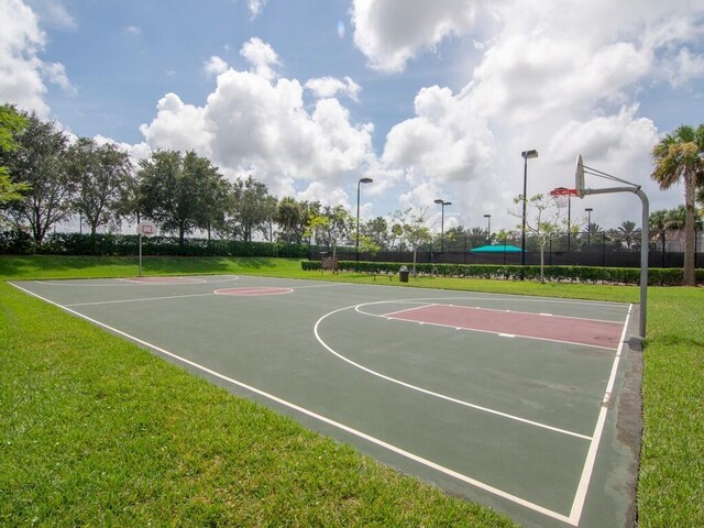 view of sport court featuring a yard