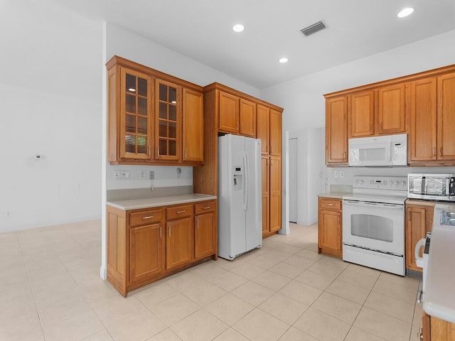 kitchen featuring light tile patterned floors and white appliances