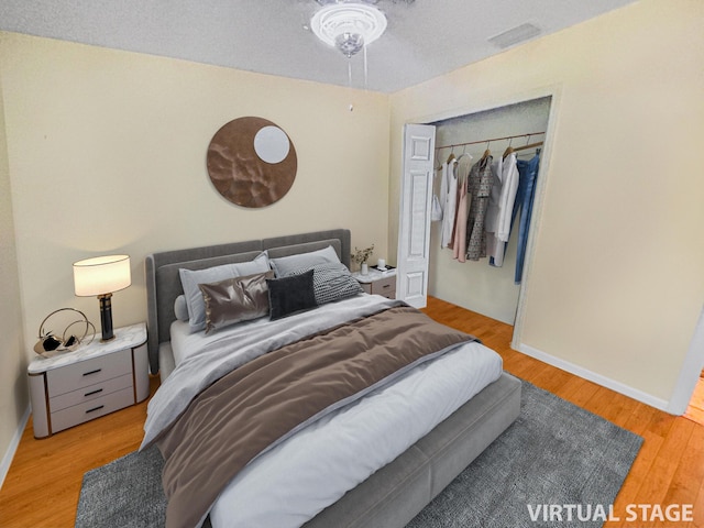 bedroom with a closet and light hardwood / wood-style flooring