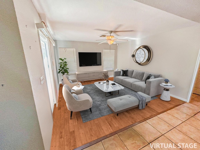 living room featuring ceiling fan and light tile patterned floors