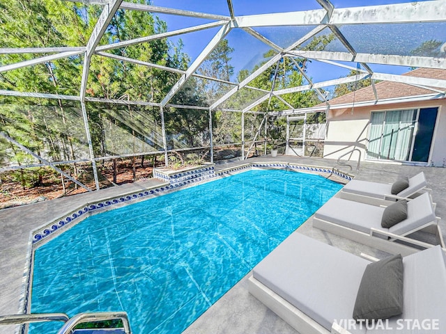 view of swimming pool featuring a patio area and glass enclosure