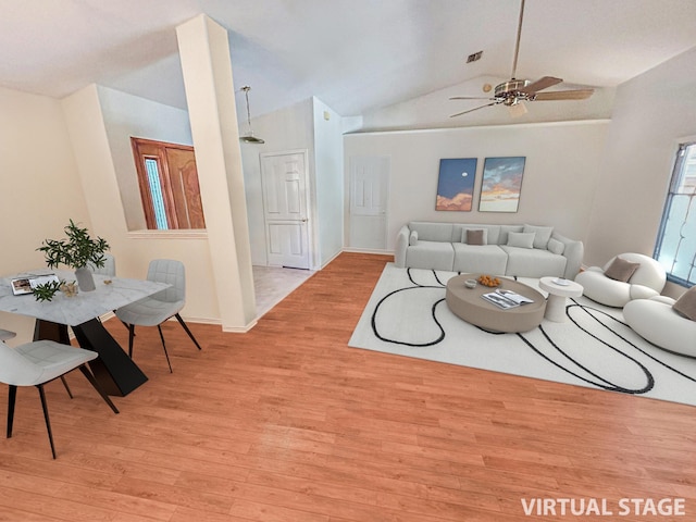 living room with ceiling fan, light hardwood / wood-style floors, and vaulted ceiling