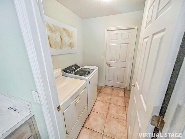 washroom featuring washer and dryer and light tile patterned floors