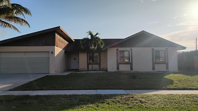 view of front of home with a front yard and a garage