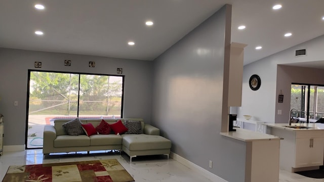 living room with sink and vaulted ceiling