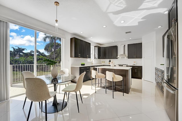 dining room with sink, light tile patterned floors, and a textured ceiling