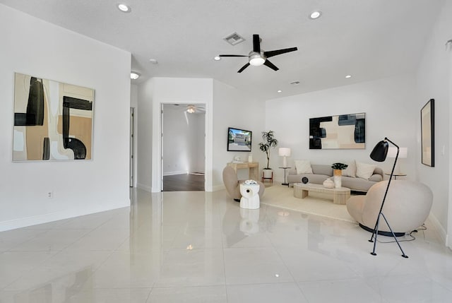 living room with a textured ceiling and ceiling fan