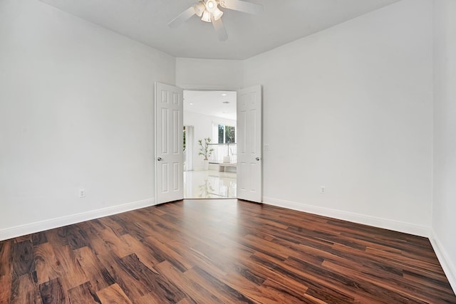 spare room featuring ceiling fan and dark hardwood / wood-style flooring