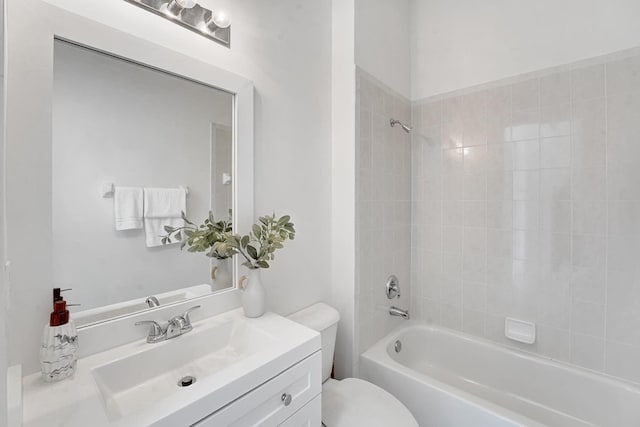 full bathroom featuring vanity, tiled shower / bath combo, and toilet