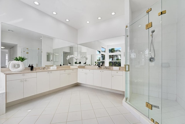 bathroom with vanity, tile patterned floors, and a shower with door