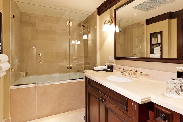 bathroom featuring combined bath / shower with glass door, vanity, and crown molding