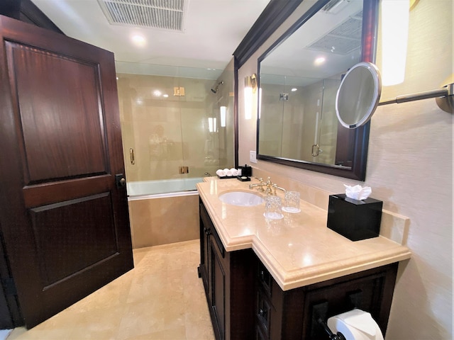 bathroom featuring shower / bath combination with glass door and vanity