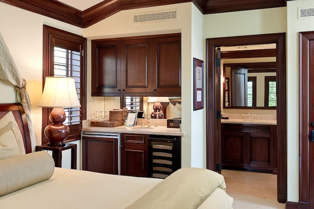 bar with crown molding, sink, and beverage cooler