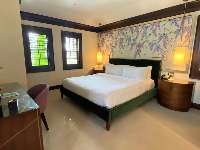 carpeted bedroom featuring ornamental molding