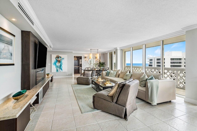 living room with a textured ceiling, light tile patterned floors, expansive windows, and ornamental molding