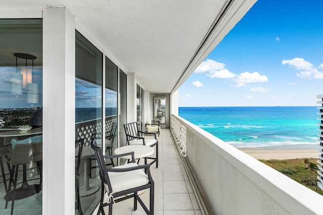 balcony with a beach view and a water view