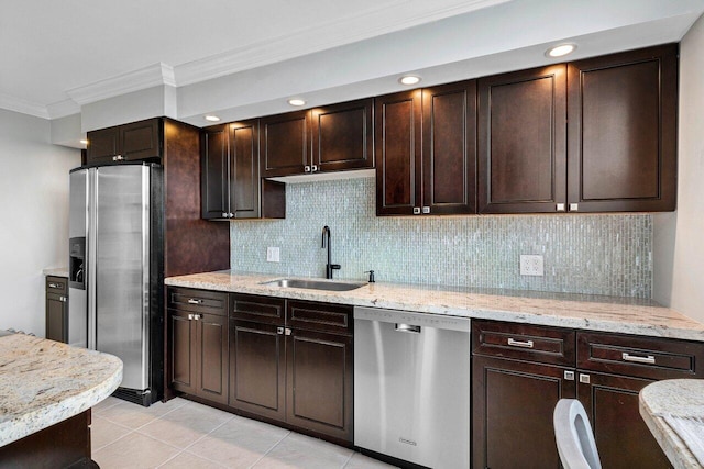 kitchen featuring dark brown cabinetry, stainless steel appliances, decorative backsplash, sink, and crown molding