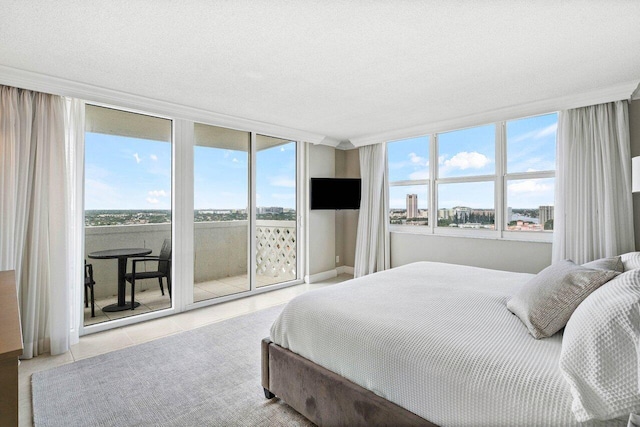 tiled bedroom with access to exterior and a textured ceiling