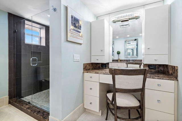 bathroom with tile patterned floors, an enclosed shower, and vanity