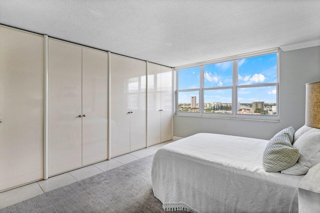 tiled bedroom featuring a textured ceiling