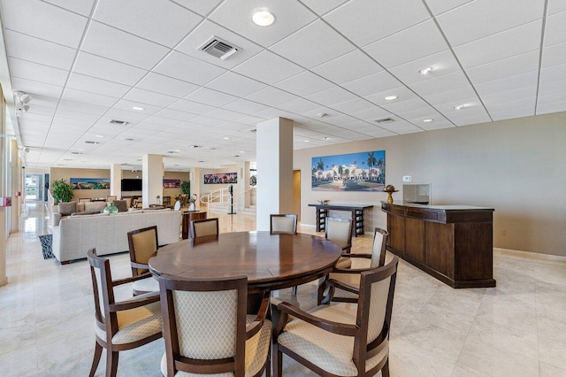 dining room with a drop ceiling